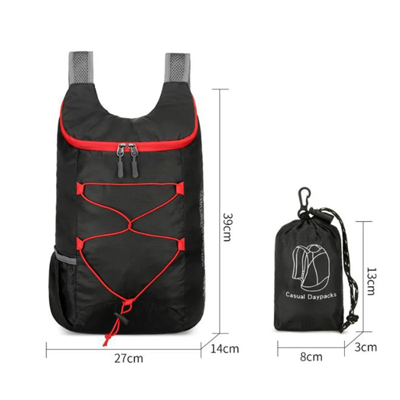 Black folding backpack with red piping, front pocket, and adjustable shoulder straps