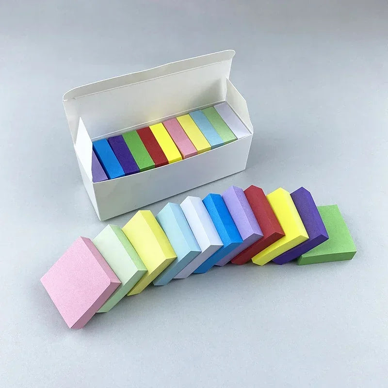 Closed white box and row of fluorescent bookmark sticky notes in assorted colors.