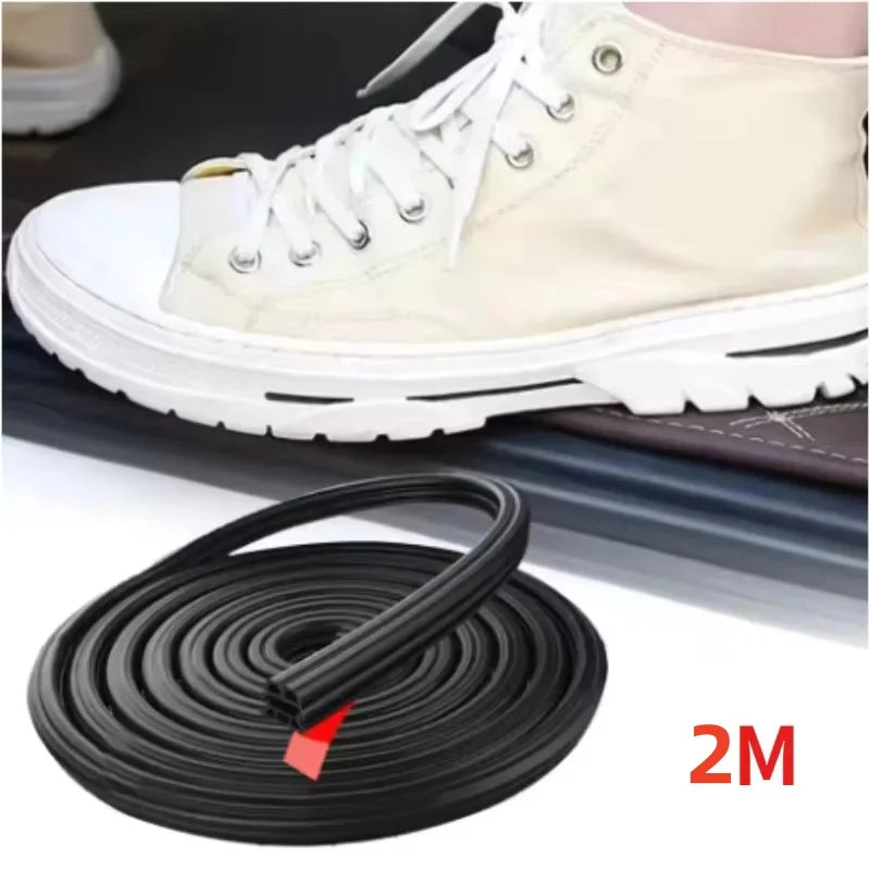 Black rubber door seal strip with coiled roll beside car door edge weatherproofing