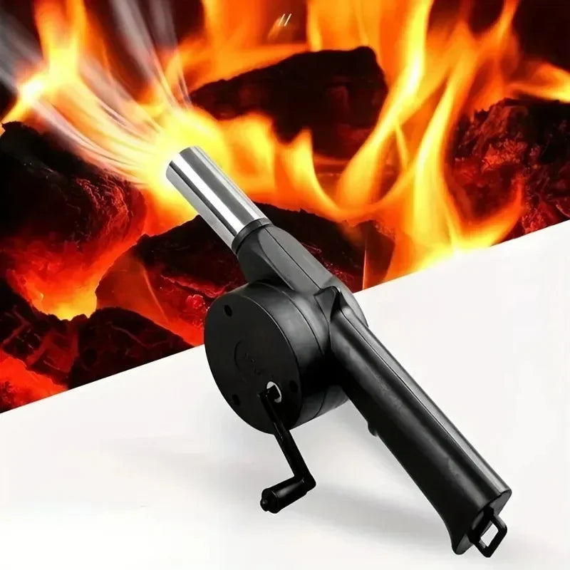 Manual BBQ air blower positioned near burning charcoal for faster ignition