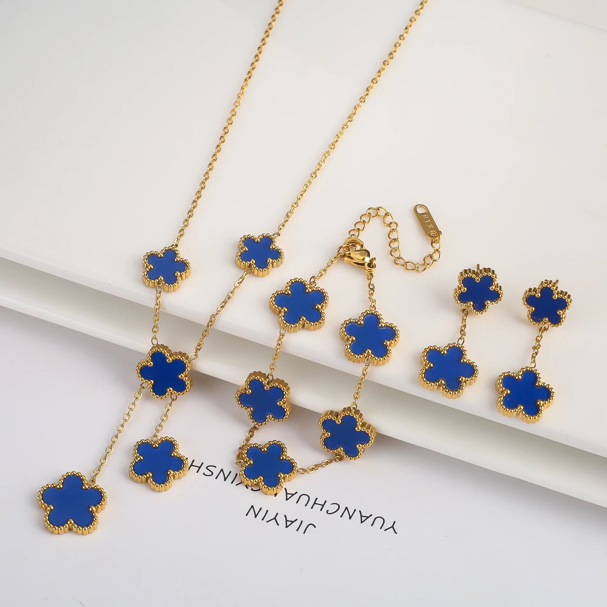 Gold-plated jewelry set with blue five-leaf flower necklaces, bracelet, and earrings