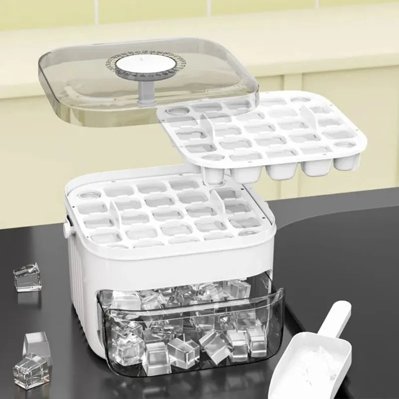 White ice cube machine with open press lid, cube molds, and ice cubes in bin.