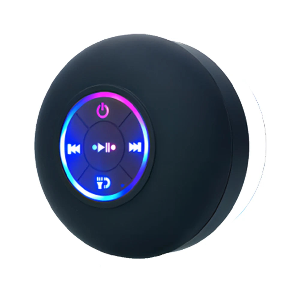 Black round wireless speaker close-up with glowing LED touch control icons
