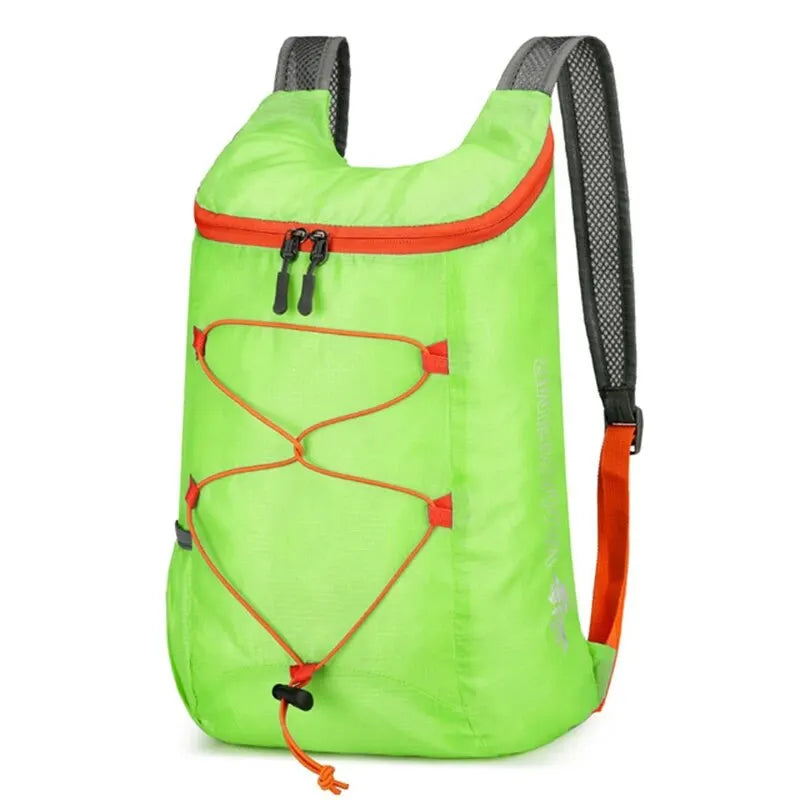 Green folding backpack with orange trim, drawstring closure, and carrying straps