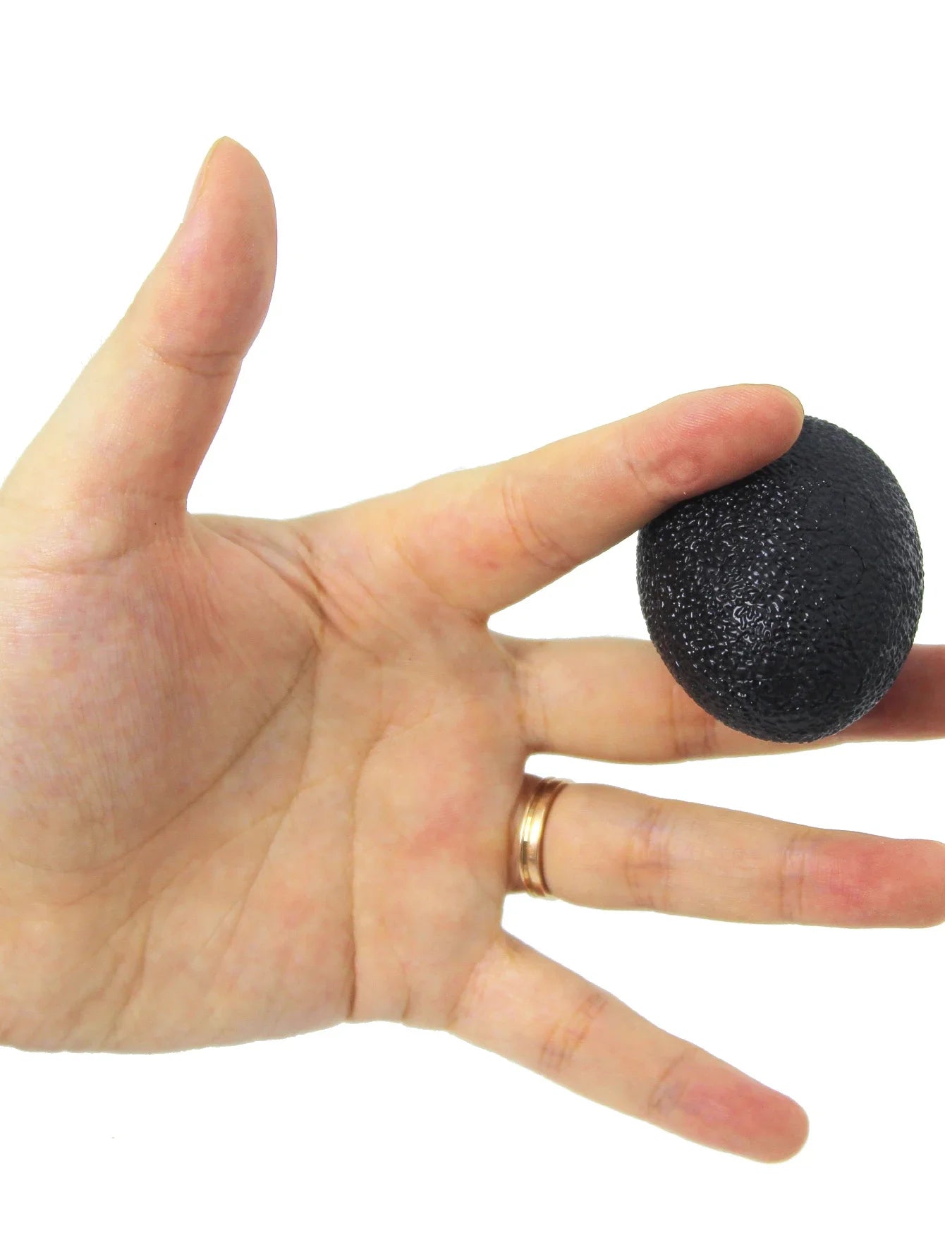 Black egg-shaped grip strength ball squeezed with palm and fingers for therapy
