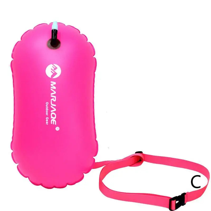 Inflatable swim buoy tow float in pink with shoulder strap and air valve