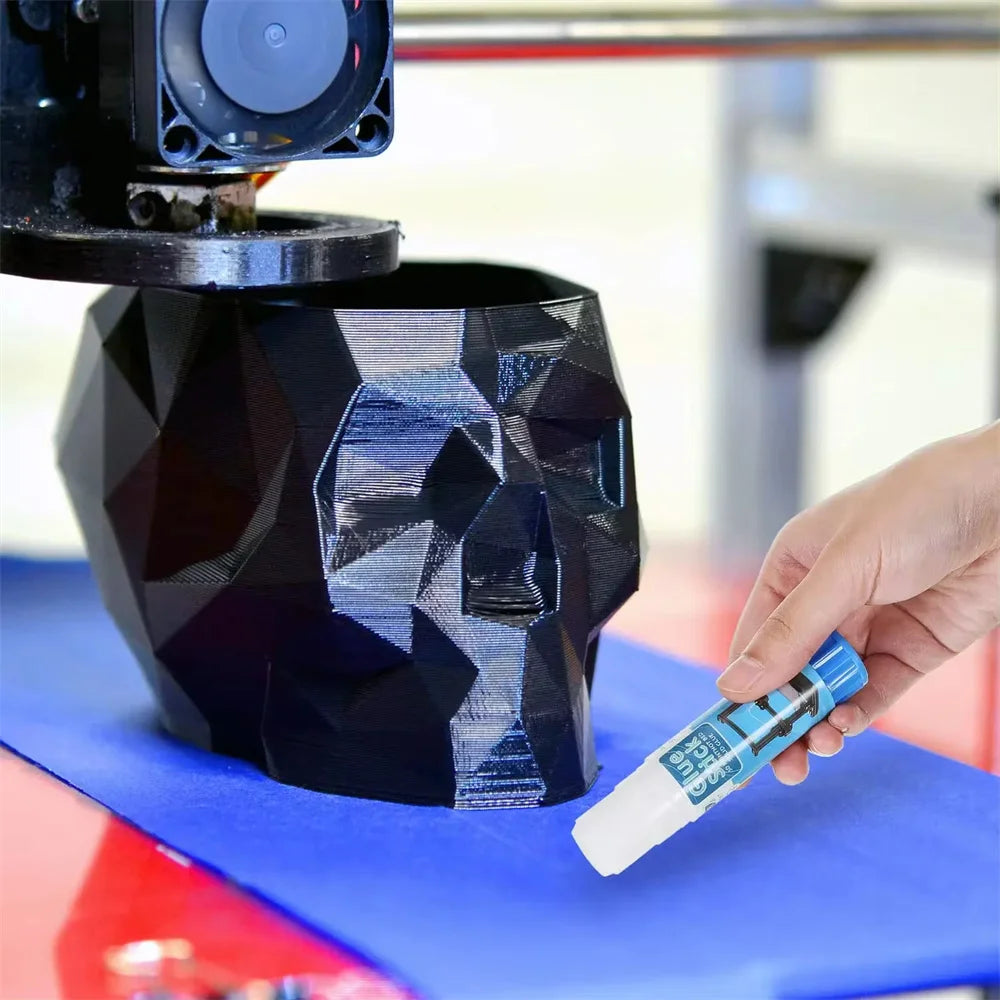 3D printer glue stick being applied to a heated bed