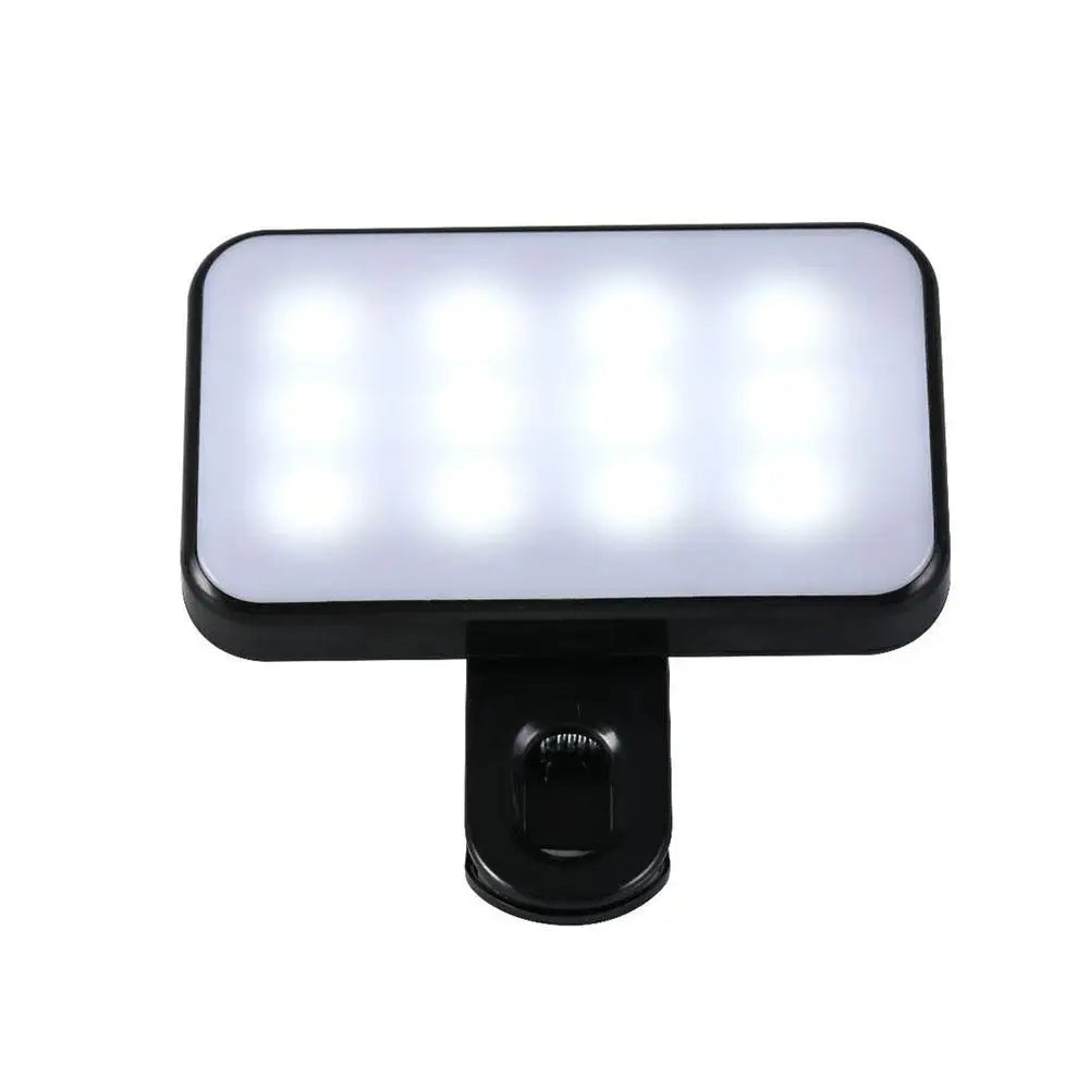 Pocket LED selfie light with clip, front view of glowing rectangular LED panel