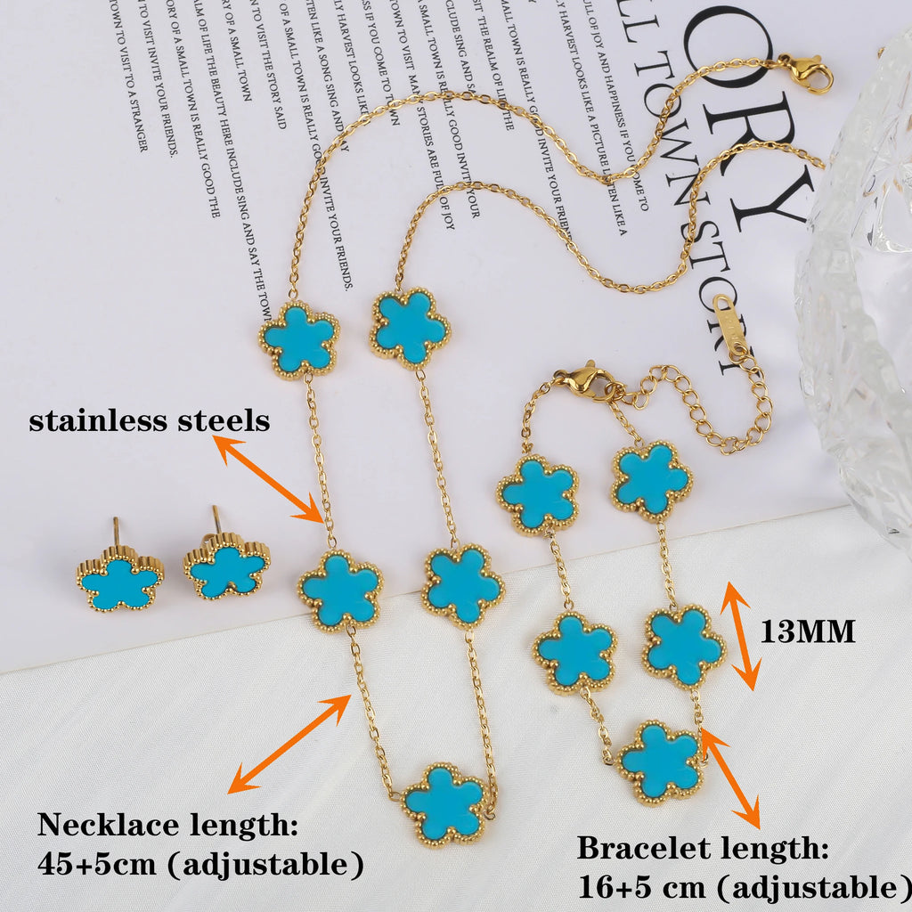 Adjustable clover charm bracelet with gold-tone chain and teal enamel four-leaf charms