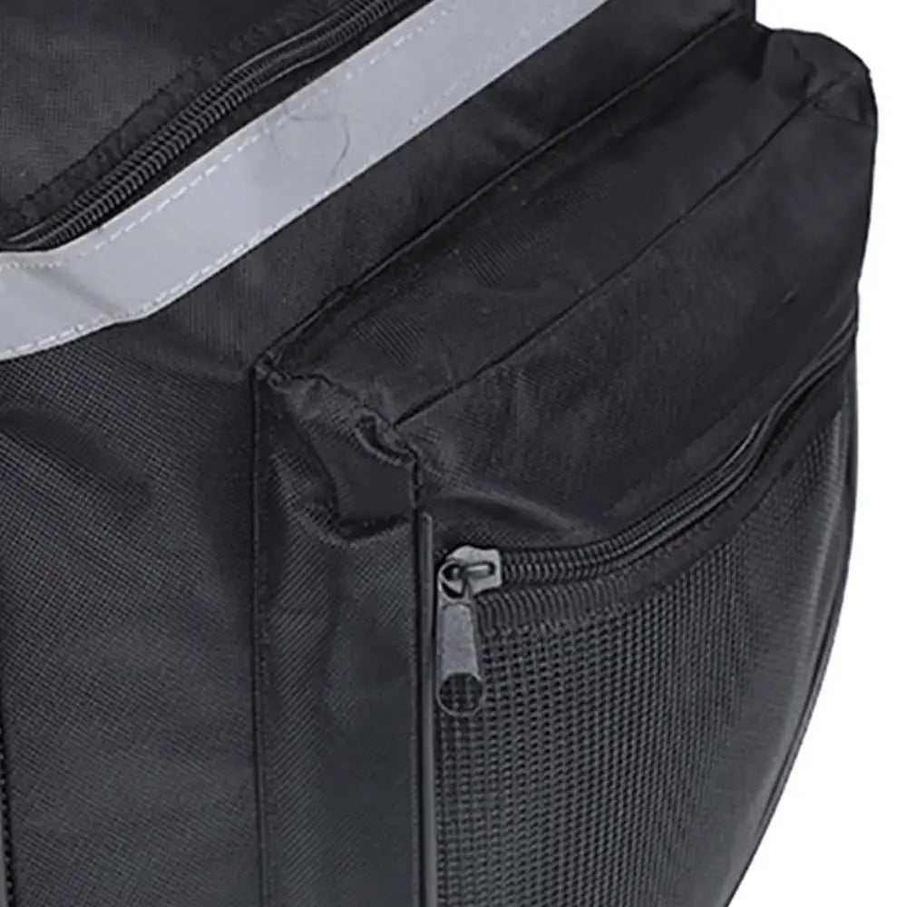 Black bicycle pannier bag side close-up with mesh panel and small front zipper pocket