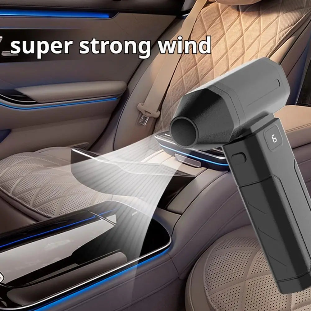 Black handheld air blower fan blowing dust from car seat cushion