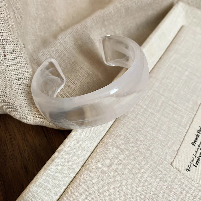 Clear translucent glossy open acrylic bangle with smooth wide open cuff