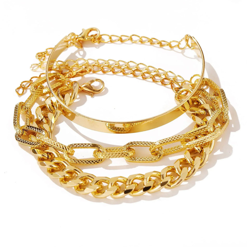 Gold open bangle bracelet set with layered chain bands and textured link cuff details