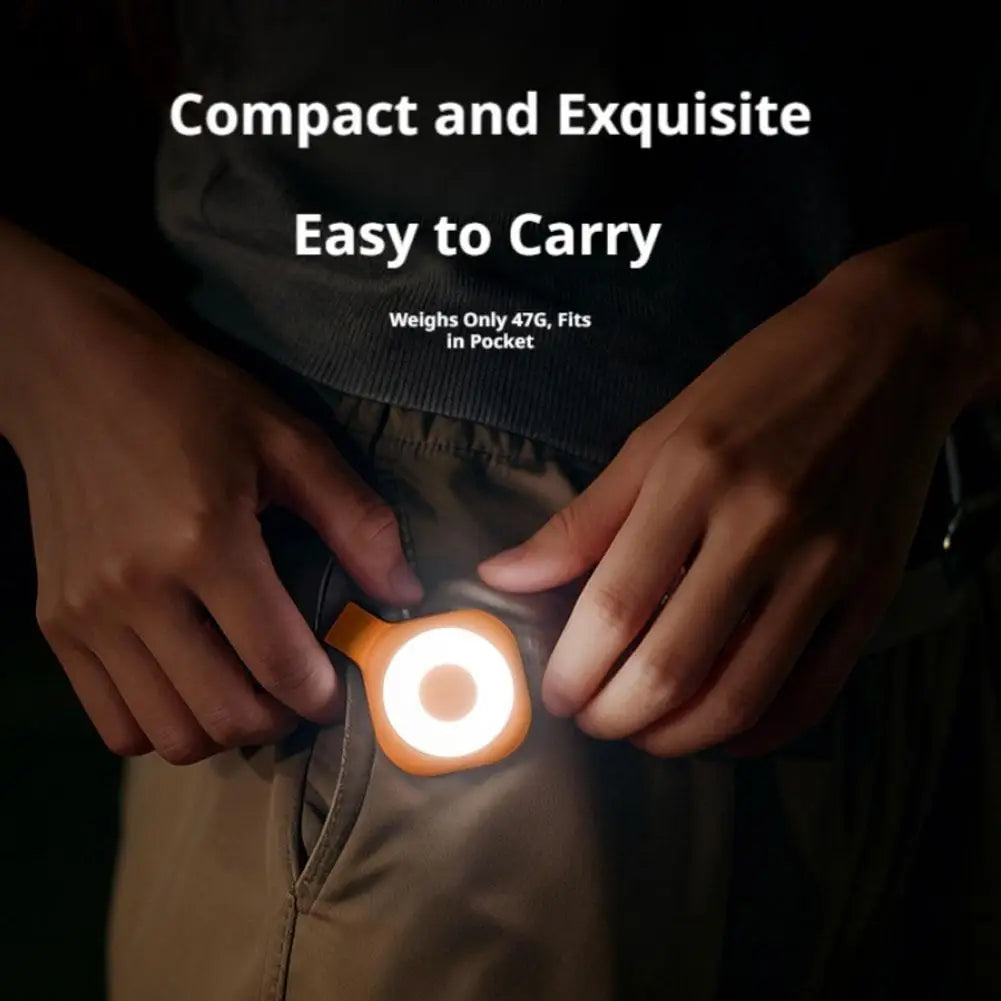 Compact magnetic LED phone light with warm glowing ring held between hands
