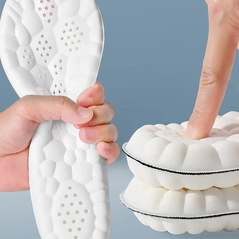 Pair of white gel-style running insoles showing shock foam pads and perforations