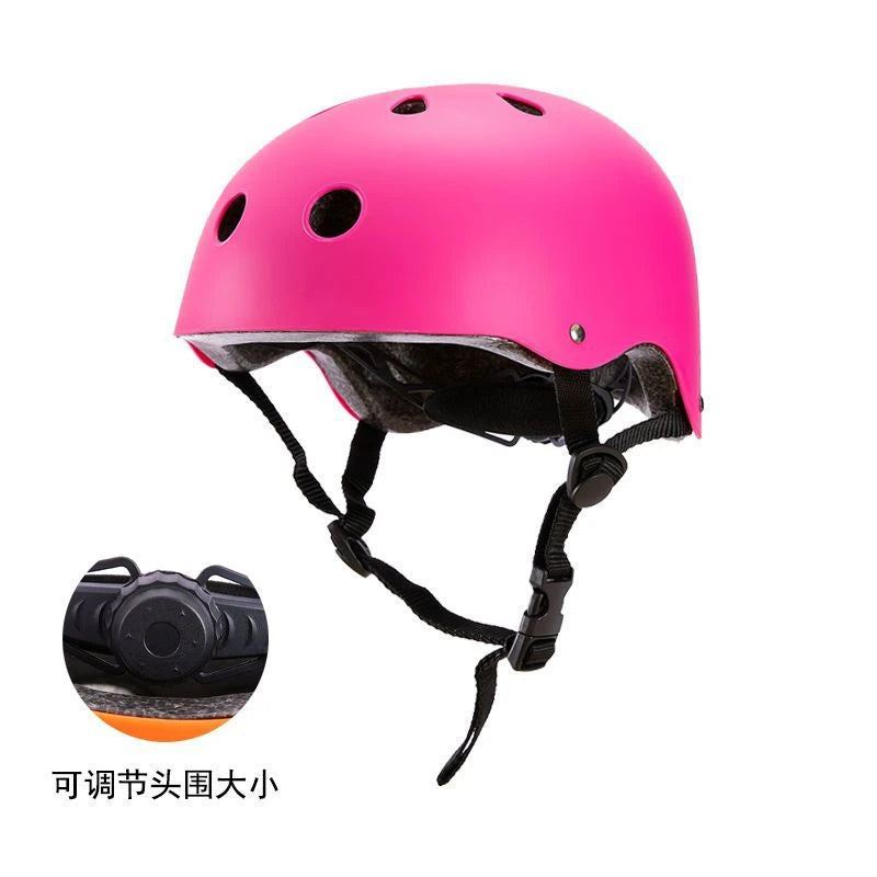 Pink kids bike helmet with ventilation holes, with adjustable fit dial close-up.