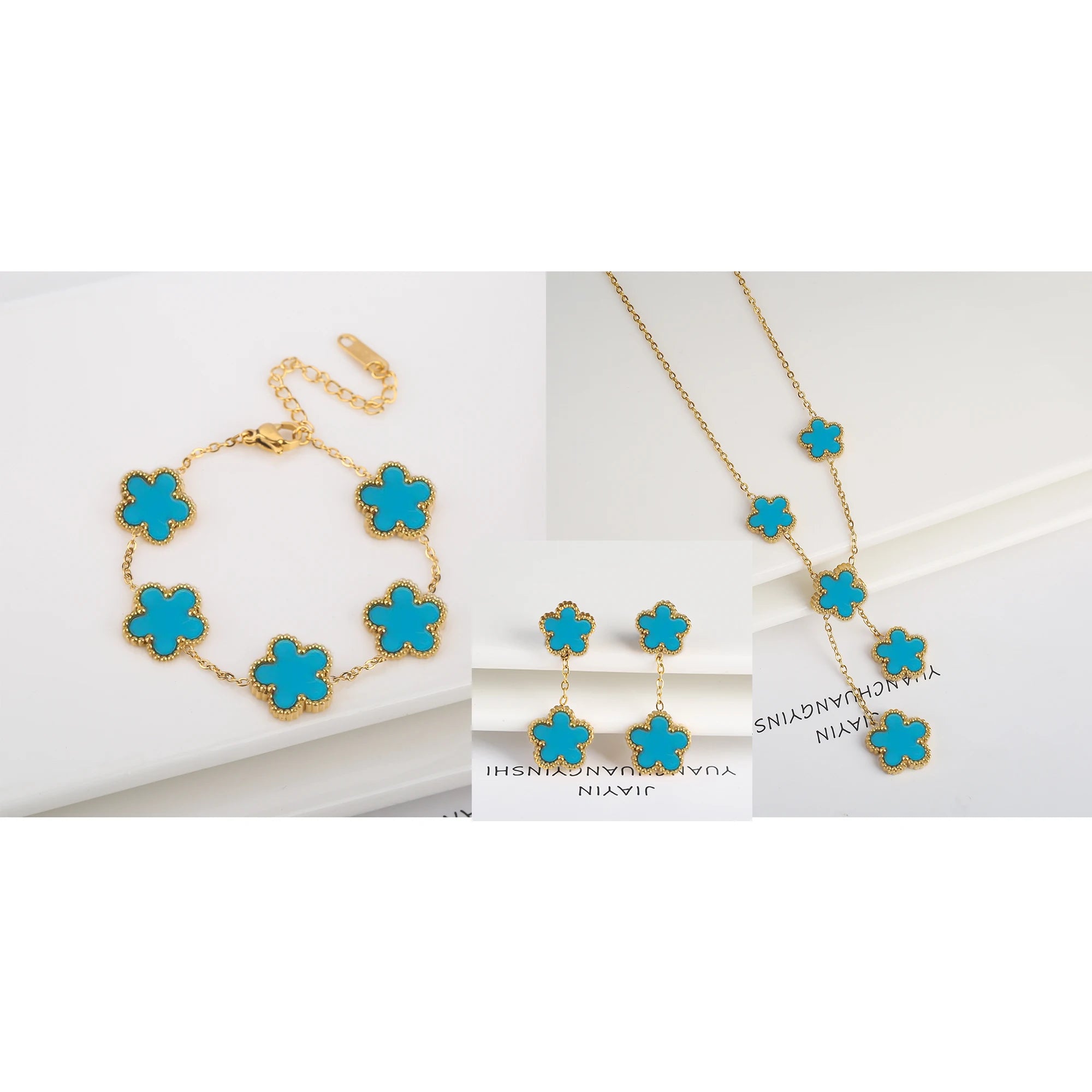 Three-piece clover jewelry set with blue enamel five-leaf charms, gold tone necklace and bracelet