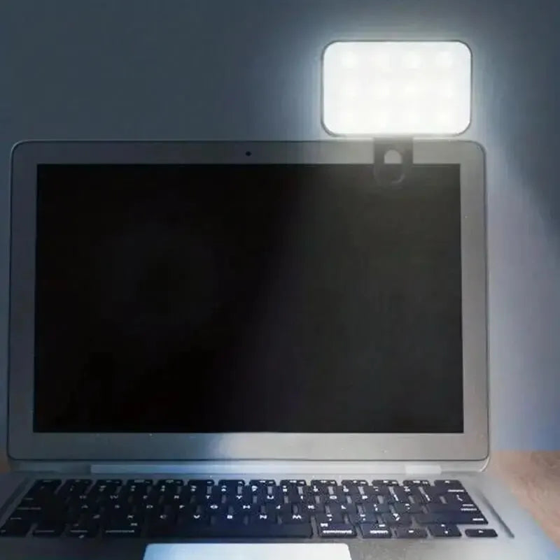 Clip-on LED fill light mounted above a laptop screen