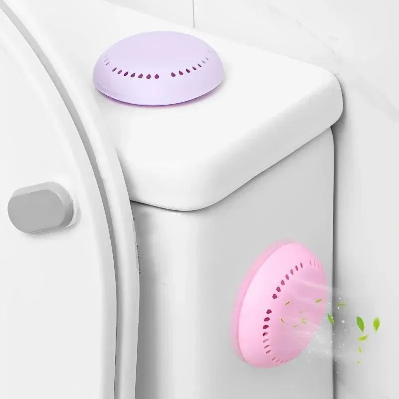 Purple round aromatherapy deodorizing tablet with dotted pattern on toilet tank lid