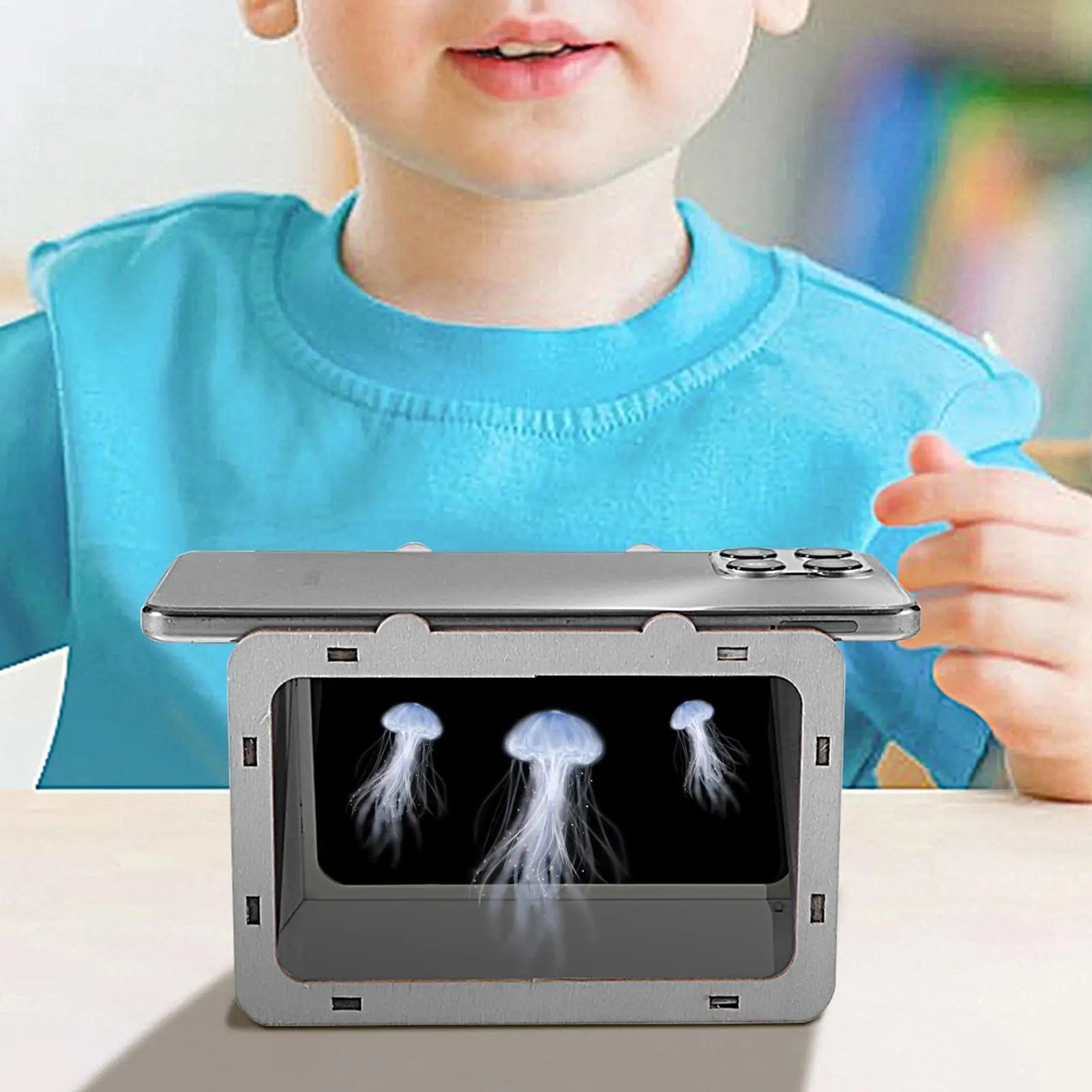 DIY 3D hologram projector held by a child, front window shows jellyfish hologram