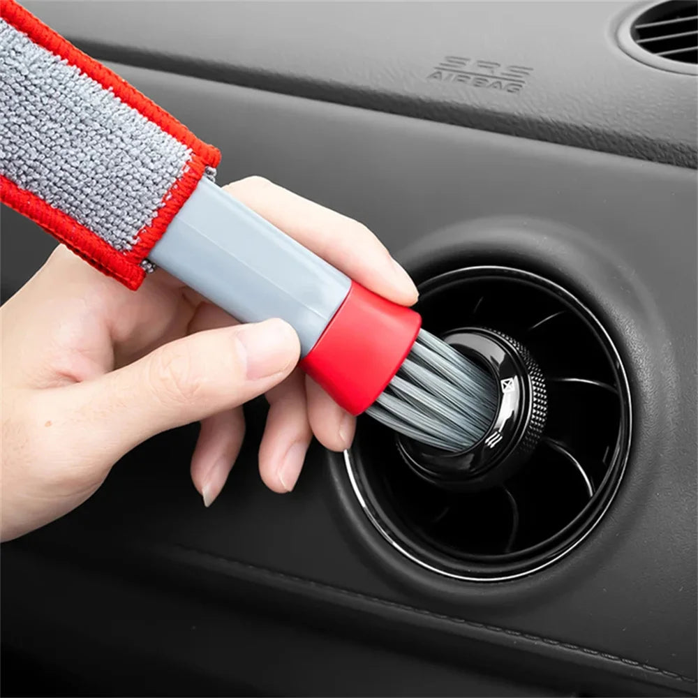 Car interior vent brush head with gray bristles and red base, used on air vent