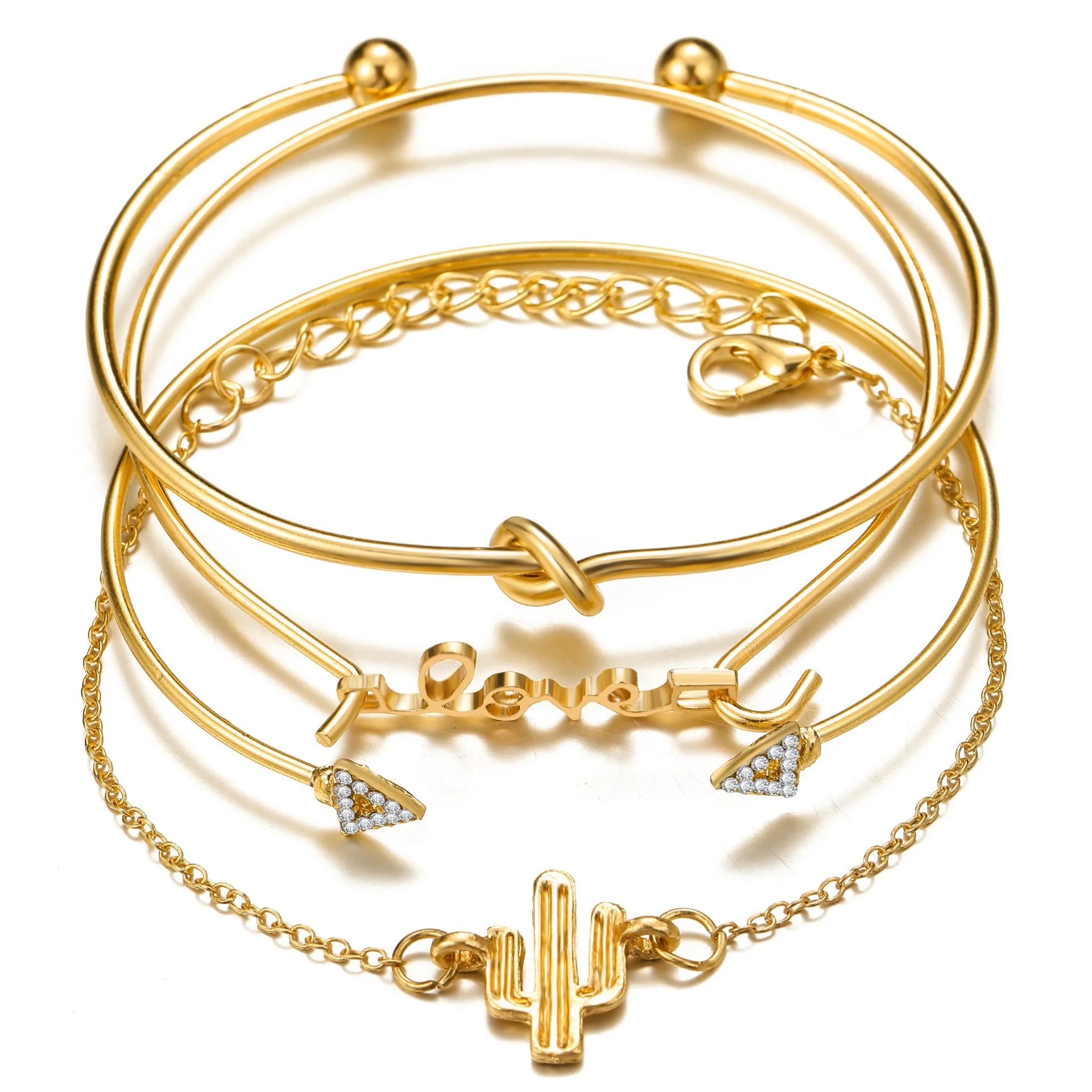 Gold-tone bracelet set with layered bangles, chain strands, and cactus charm