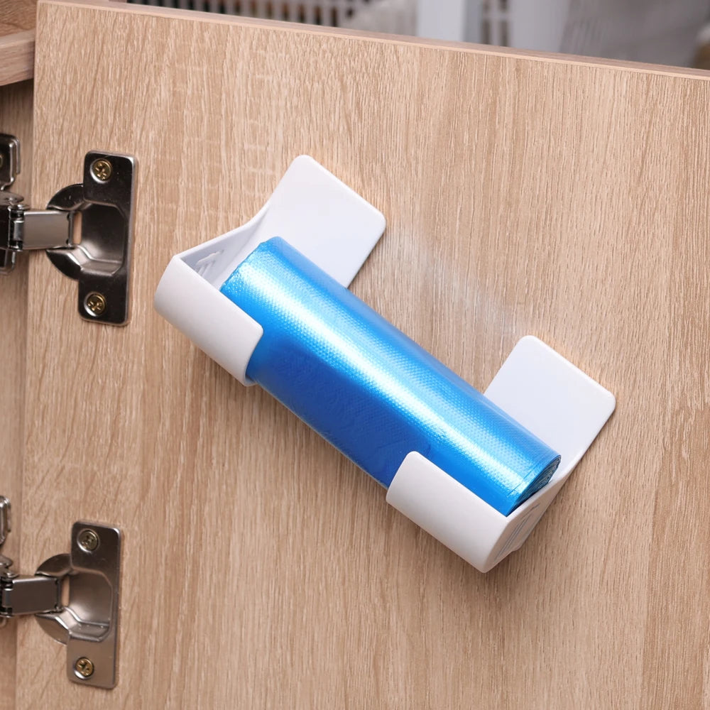 Wall-mounted trash bag holder with blue bag roll, white plastic bracket on door