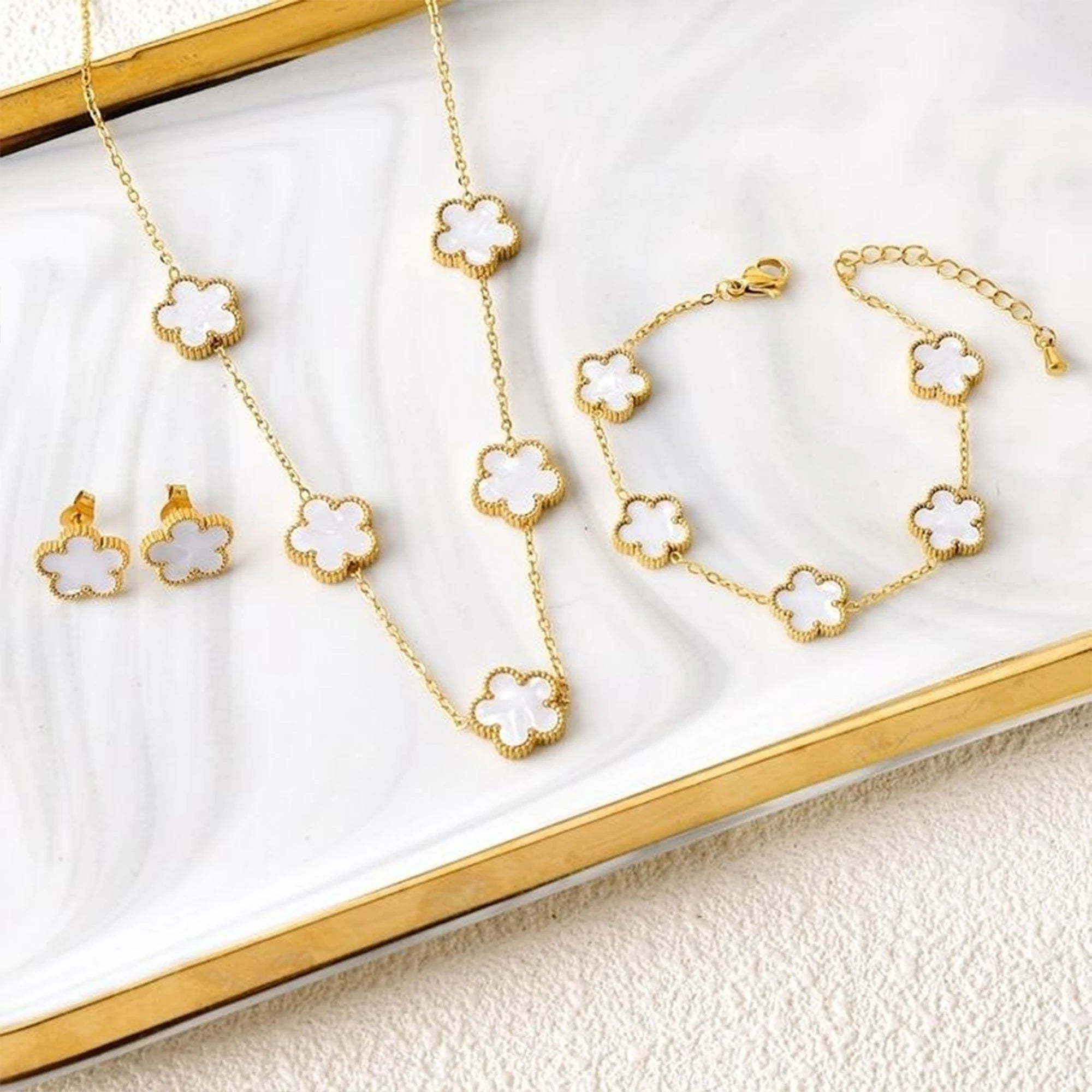 Gold-plated jewelry set with white four-/five-leaf flower necklaces, bracelet, and earrings