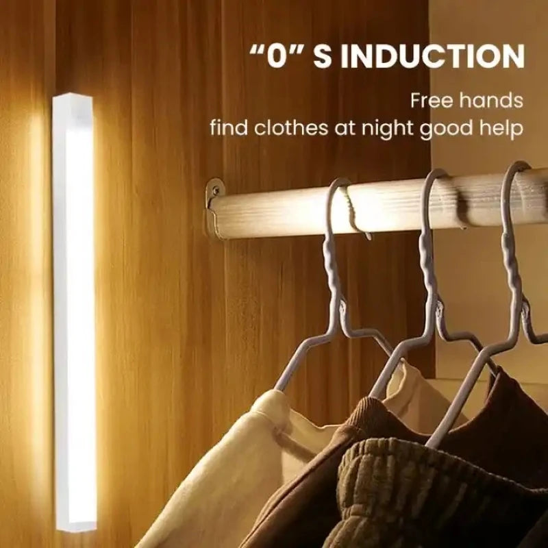 Motion sensor LED strip night light, slim vertical bar glowing on a wooden closet door