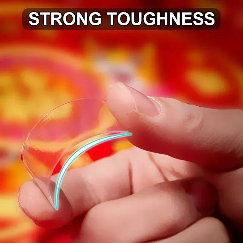 Transparent curved double-sided adhesive tape strip held between fingers.