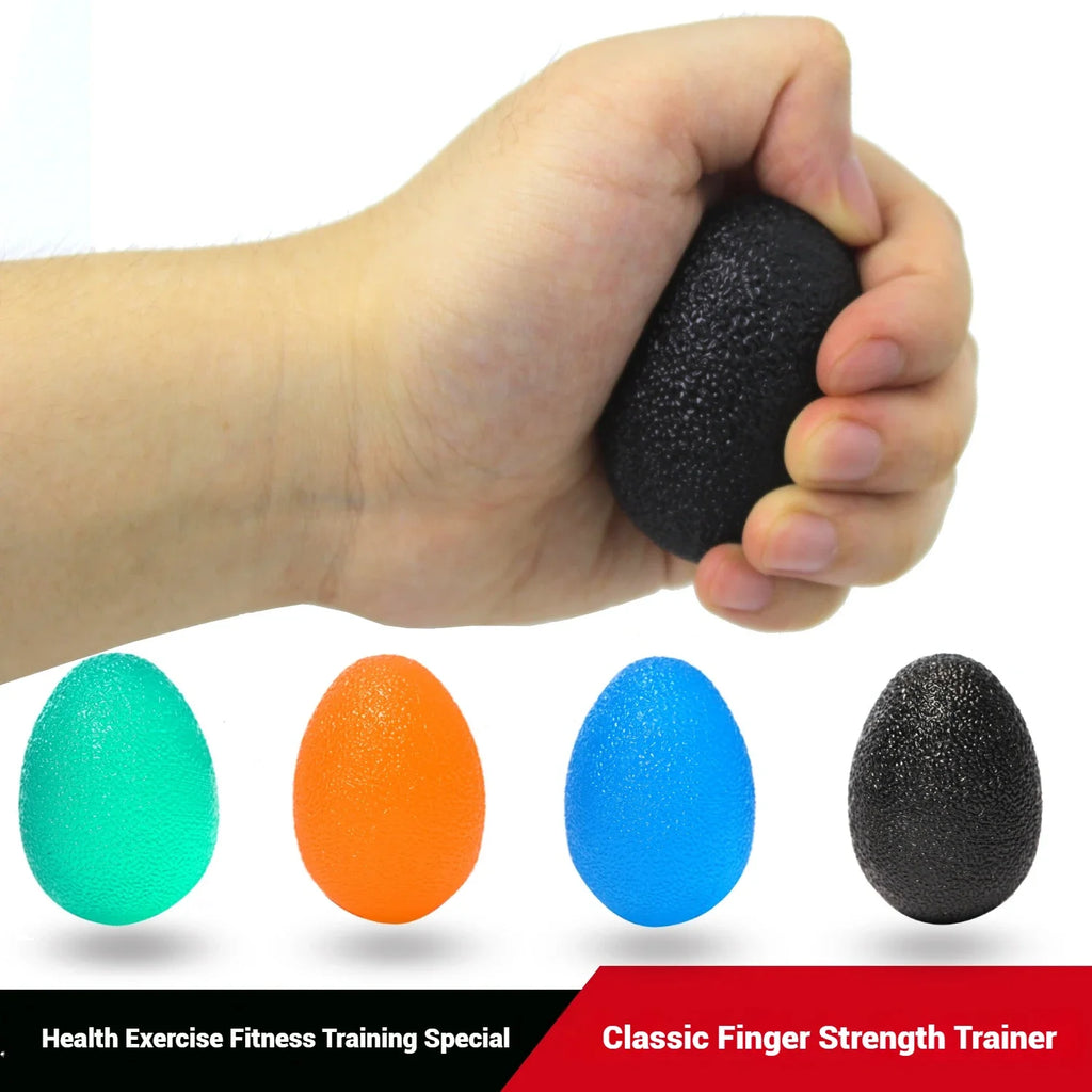 Hand squeezing a black textured egg grip ball; orange, green, blue balls shown below.
