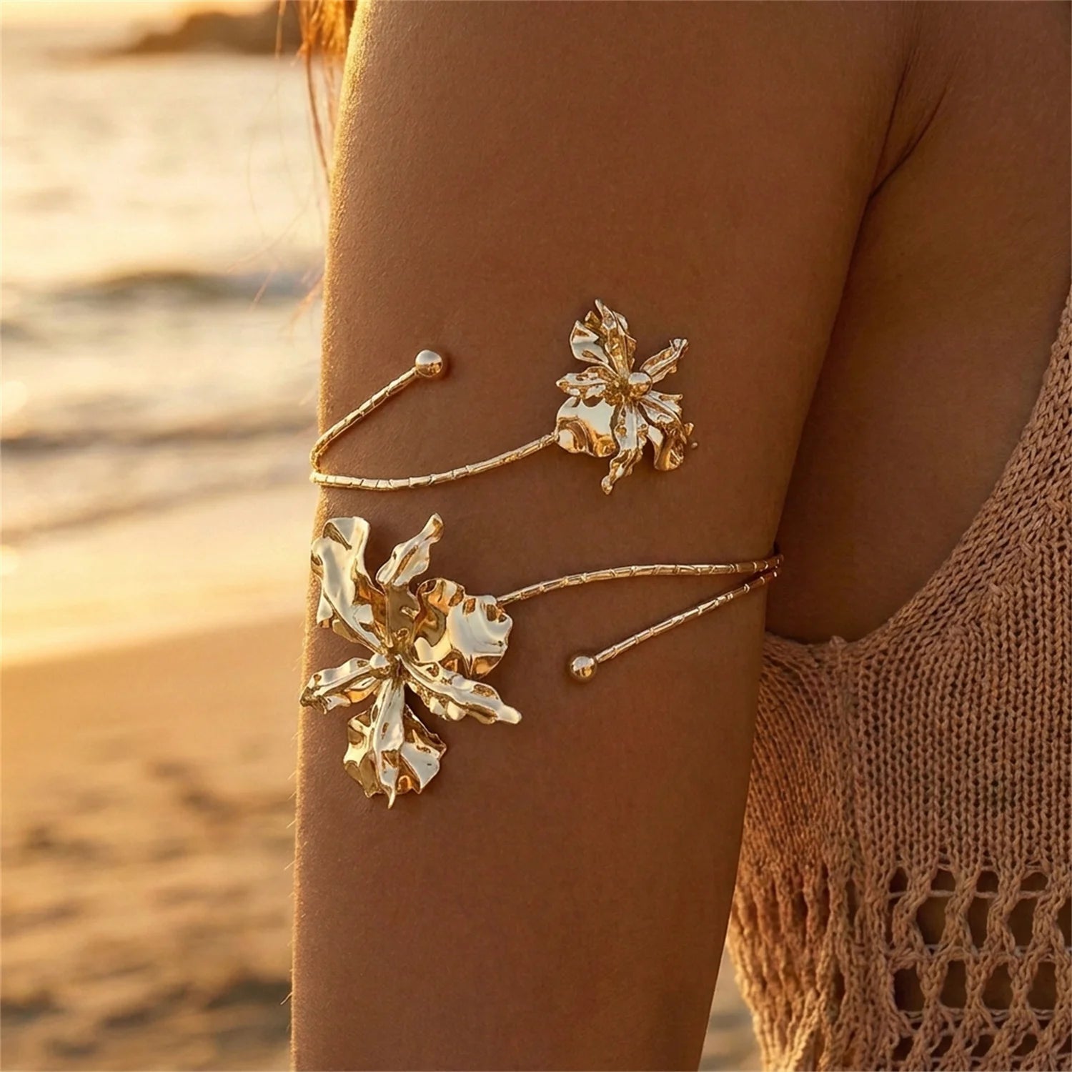 Gold open cuff arm bracelet with white enamel flower clusters and dangling bead details