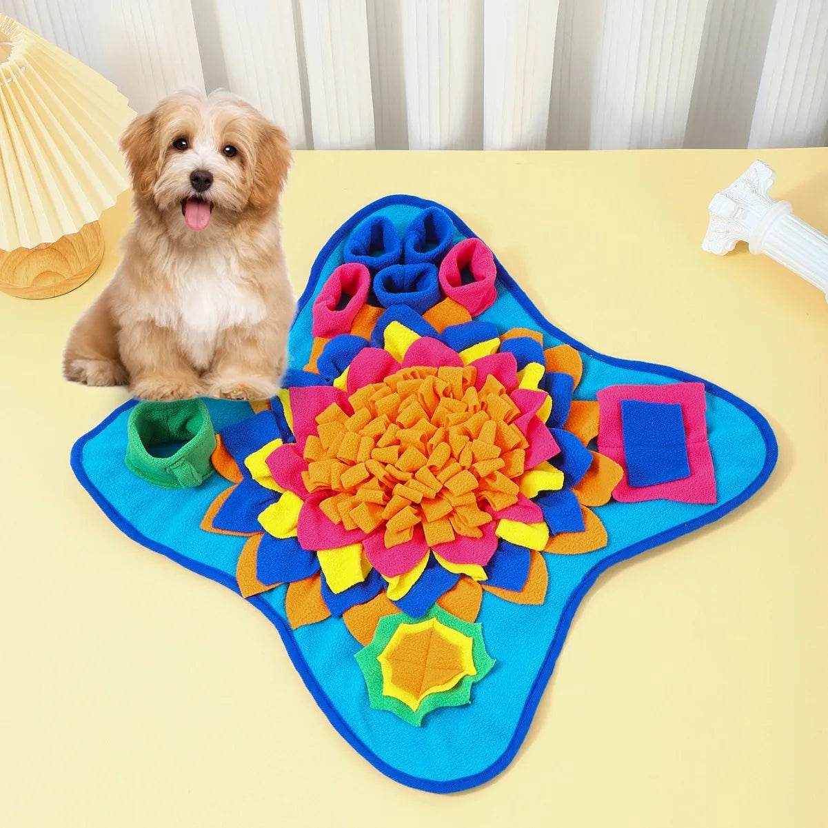 Blue star-shaped fleece snuffle mat with orange-yellow flower center and green loop pocket