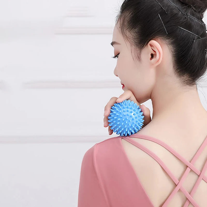Blue spiked massage fascia ball used at the neck for targeted relief
