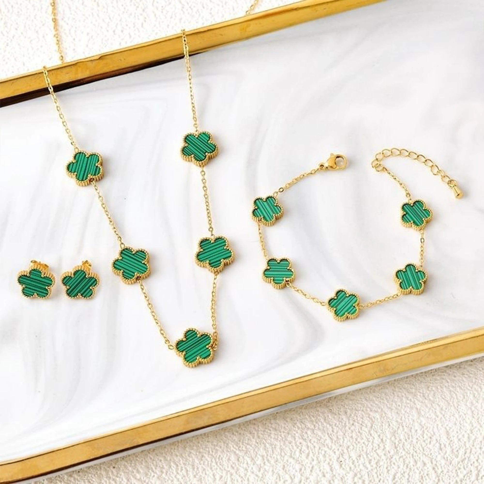 Gold-plated jewelry set with green five-leaf flower necklaces, bracelet, and earrings
