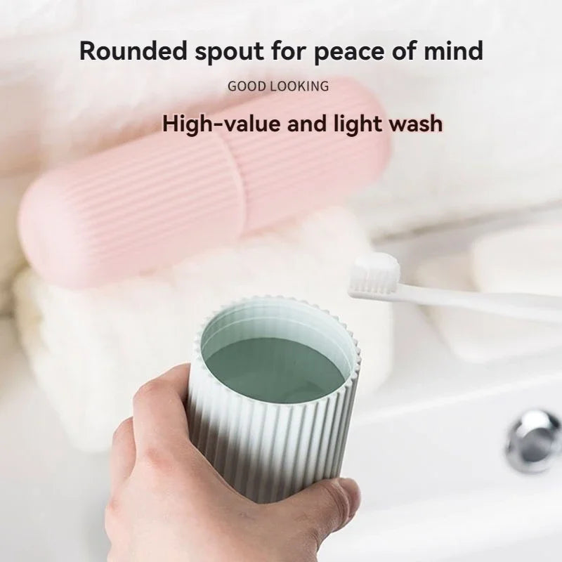 Pink ribbed travel mouthwash cup holding water with toothbrush