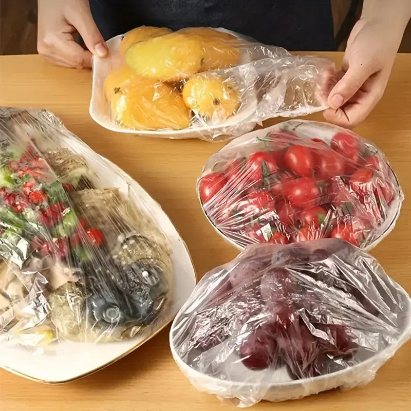 Disposable clear food cover plastic wrap covering bowls of vegetables and fruit