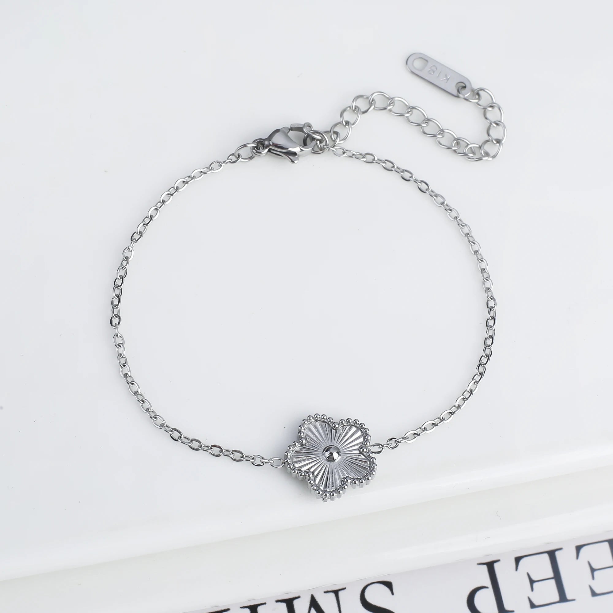 Adjustable silver bracelet with five scalloped flower medallion charms and chain