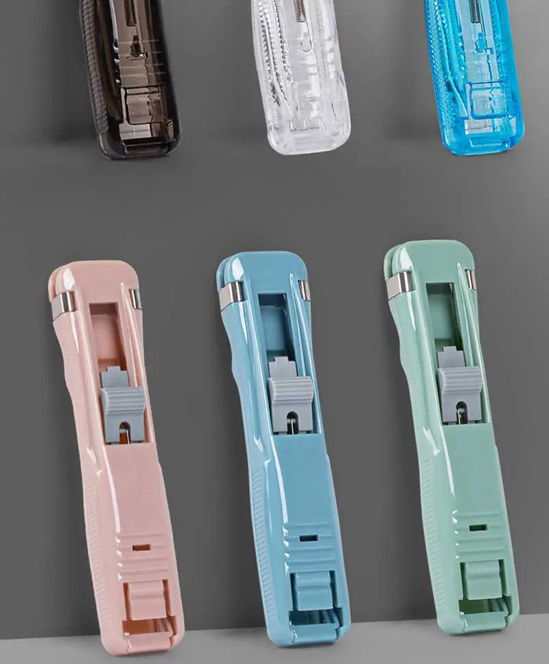 Pastel reusable push paper stapler clamps in pink, light blue, and green