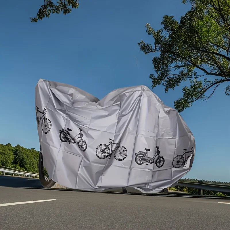 Gray outdoor bike cover with bicycle print, covering a parked bicycle on the road