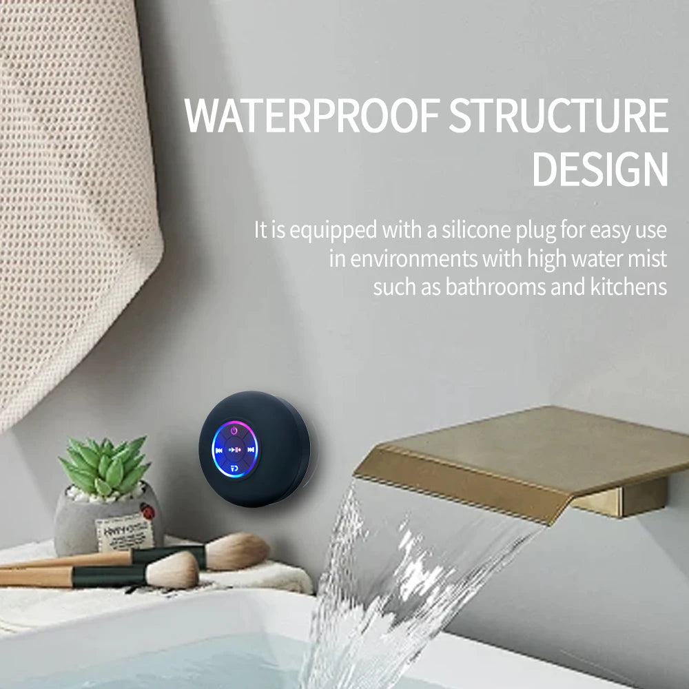 Black Bluetooth speaker with RGB light ring on a bathroom sink ledge, water splashing toward it