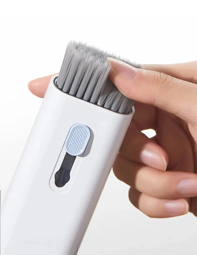 White cleaning brush head with dense bristles held in a hand