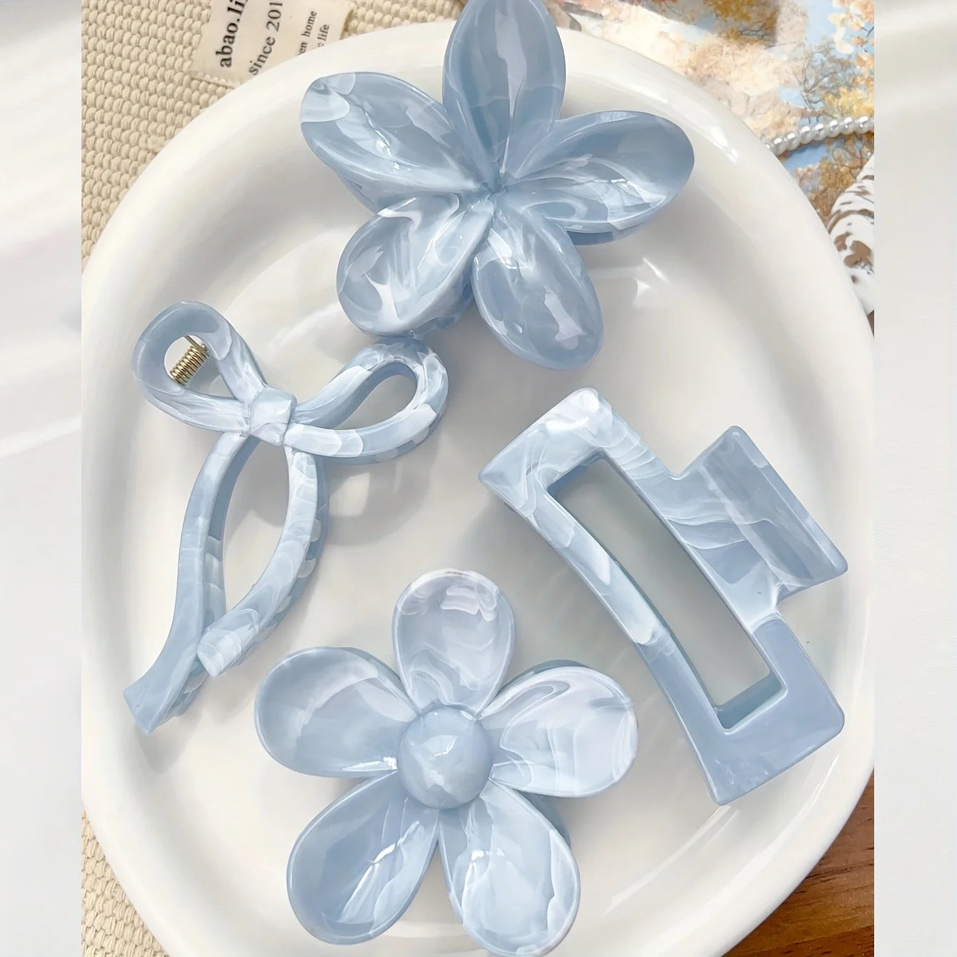 Light blue daisy flower hair claw with ribbon bow and rectangular claw clip