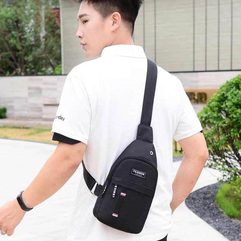 Black waterproof fanny pack worn crossbody with adjustable strap and front zip pocket