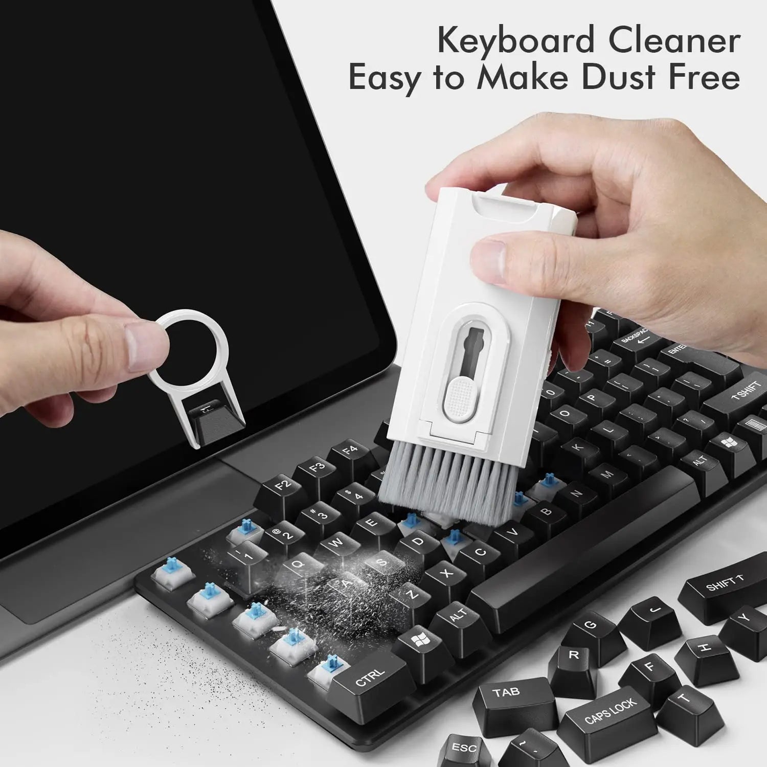 Handheld keyboard cleaning brush sweeping between keycaps