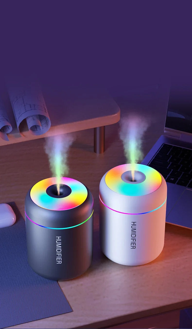 Pair of mini humidifiers, black and white, with rainbow LED tops and mist