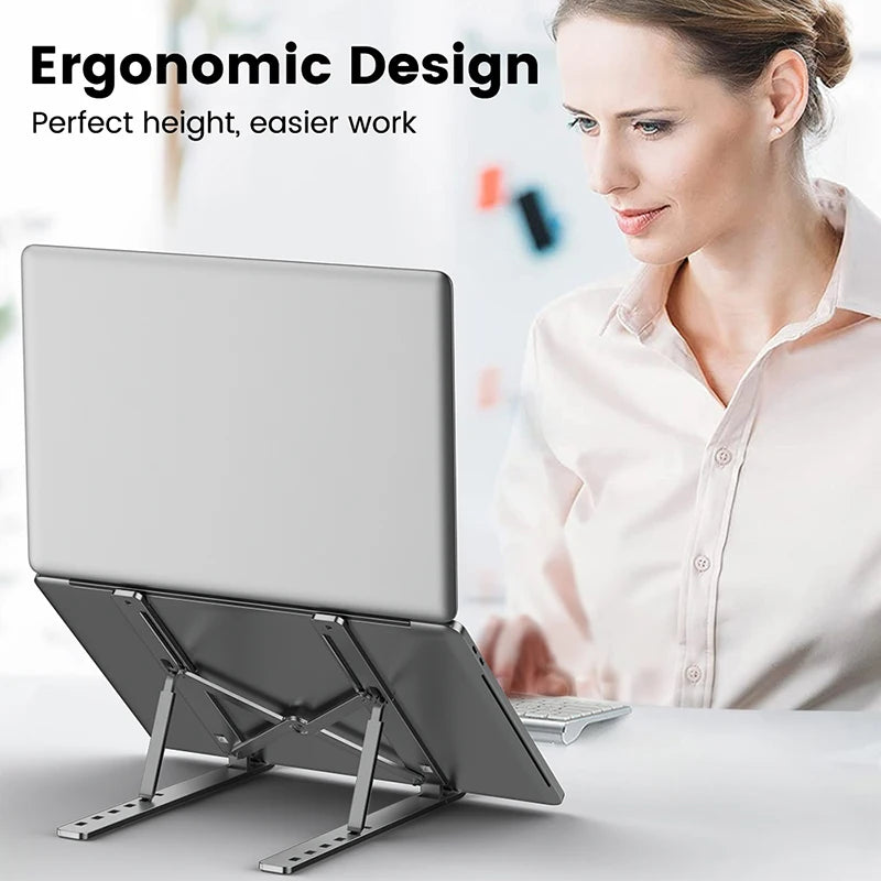 Silver metal laptop stand raised for typing, with multi-angle folding legs