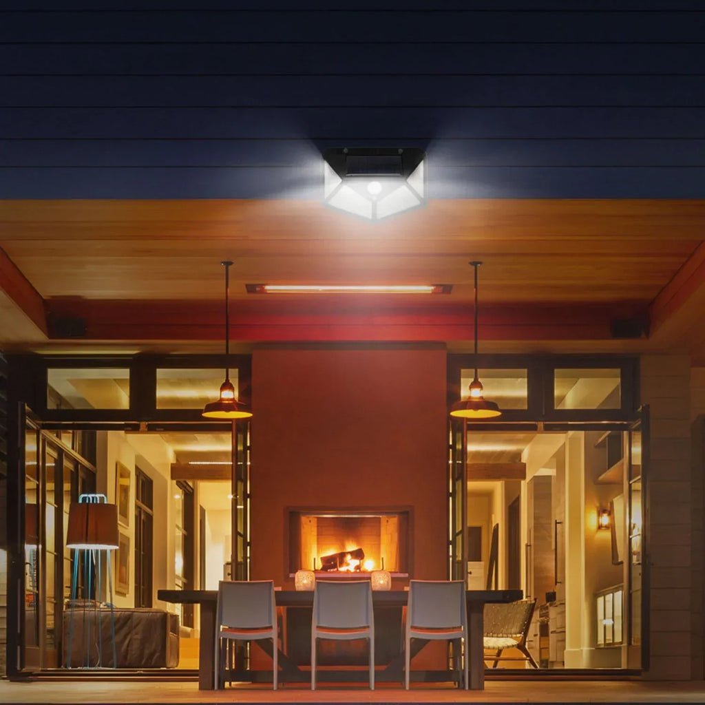 Ceiling-mounted style solar LED motion light casting bright light outdoors, black fixture