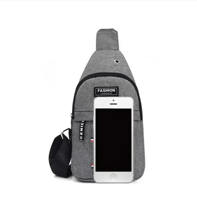 Gray crossbody fanny pack with front zipper pocket holding a smartphone