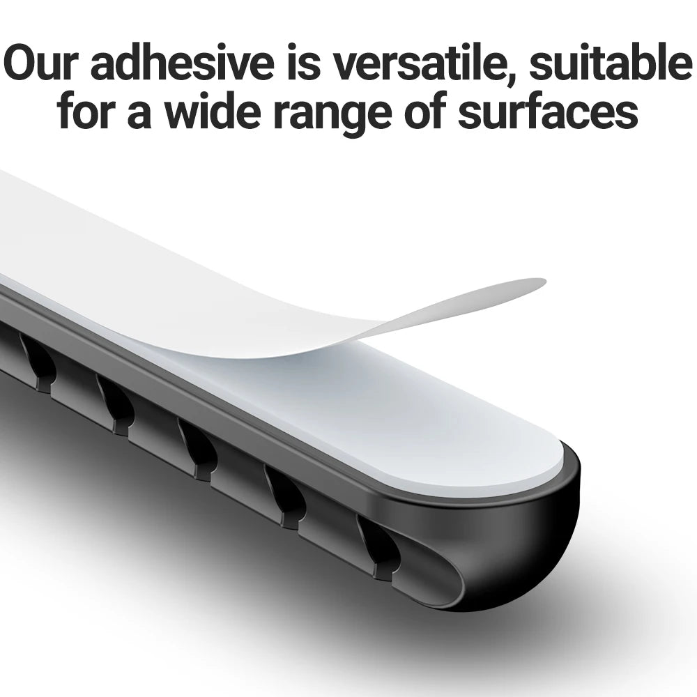 Black adhesive cable holder clip attached under desktop edge with cord channels